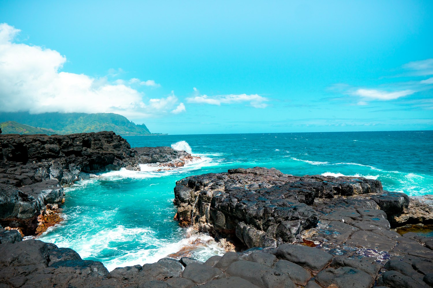 Turquoise water against the black lava coastline of the Big Island of Hawaii